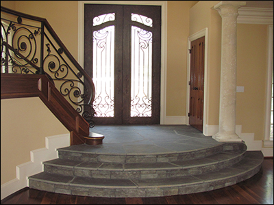 A beautiful stairway leads to a wonderful home entrance.